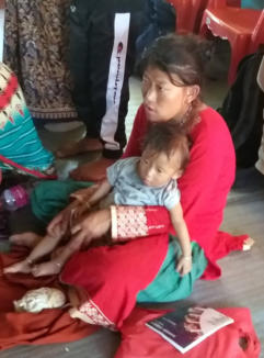 Mother with baby healed of paralysis